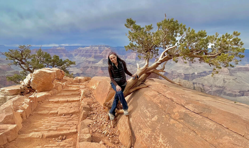 Lisa Medoff posing by beautiful desert cliffs
