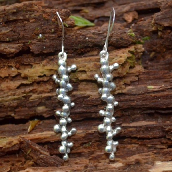 long straight earrings with small twig-like knobs and ridges